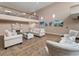 Community area with comfortable seating, decorative fireplace, soaring ceilings and staircase at 2290 Aaron St # 312, Port Charlotte, FL 33952