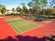 Outdoor tennis courts with green playing surfaces and red surrounding areas at 2290 Aaron St # 312, Port Charlotte, FL 33952