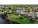 Aerial view showcases the home's backyard, screened-in pool area, landscaping, and neighborhood surroundings at 23240 Fullerton Ave, Punta Gorda, FL 33980