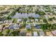 Aerial view of neighborhood showcasing a serene lake and the surrounding homes with well-maintained landscaping at 23240 Fullerton Ave, Punta Gorda, FL 33980