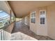 Long, tiled balcony featuring a wood railing and screened enclosure at 23240 Fullerton Ave, Punta Gorda, FL 33980