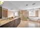 Beautiful bathroom features a soaking tub, glass shower, double sinks, and tile flooring at 23240 Fullerton Ave, Punta Gorda, FL 33980