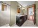 Bathroom showcasing double sinks, granite countertop, tiled shower and natural light at 23240 Fullerton Ave, Punta Gorda, FL 33980