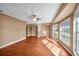 Expansive bedroom features beautiful hardwood flooring, ceiling fan, and a bright bay window at 23240 Fullerton Ave, Punta Gorda, FL 33980