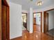 Hallway view with bathroom, closet and bedroom entrances plus hardwood floors at 23240 Fullerton Ave, Punta Gorda, FL 33980