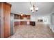 Open concept kitchen with wood cabinets, stainless appliances, and tiled floors at 23240 Fullerton Ave, Punta Gorda, FL 33980
