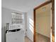 Bright laundry room with a window providing natural light and convenient access to closet space at 23240 Fullerton Ave, Punta Gorda, FL 33980