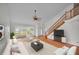 Bright and airy living room with large windows and staircase at 23240 Fullerton Ave, Punta Gorda, FL 33980