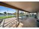 Covered patio with tile floors overlooks the pool and lake, providing a serene outdoor living space at 23240 Fullerton Ave, Punta Gorda, FL 33980