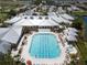 Stunning aerial view of the community pool with plenty of lounge chairs, well-maintained grounds, and a spa at 24321 Kintail Ct, Punta Gorda, FL 33980