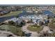 Stunning aerial view of community center with pool, golf course, and beautiful surrounding homes at 24321 Kintail Ct, Punta Gorda, FL 33980