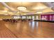 Large banquet room featuring a wood dance floor and stage for your special events at 24321 Kintail Ct, Punta Gorda, FL 33980
