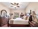 Cozy bedroom with a ceiling fan, four-poster bed, and ample natural light at 24321 Kintail Ct, Punta Gorda, FL 33980