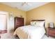 Bedroom with floral comforter, ceiling fan, and a view of the outside at 24321 Kintail Ct, Punta Gorda, FL 33980