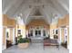 Inviting community clubhouse entrance with benches, lush landscaping, and a welcoming atmosphere for residents and visitors at 24321 Kintail Ct, Punta Gorda, FL 33980