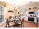 Cozy dining area with a glass-top table, stylish chandelier, and stainless steel appliances at 24321 Kintail Ct, Punta Gorda, FL 33980