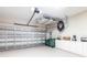 Clean garage with storage cabinets, overhead rack, lots of lighting, and lots of room for storage and equipment, plus roll up door at 24321 Kintail Ct, Punta Gorda, FL 33980