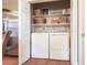 Convenient laundry room featuring a washer, dryer, and shelving for storage at 24321 Kintail Ct, Punta Gorda, FL 33980