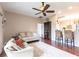 Bright living room with hardwood floors, ceiling fan, and open floor plan at 24321 Kintail Ct, Punta Gorda, FL 33980