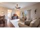 Comfortable living room featuring hardwood floors, a ceiling fan, and access to the outdoor patio at 24321 Kintail Ct, Punta Gorda, FL 33980