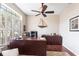 Well-appointed office with a large desk, comfortable chair, and ample natural light from the window at 24321 Kintail Ct, Punta Gorda, FL 33980