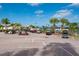 View of the community's parking lot for golf carts in front of the tennis courts on a sunny day at 24321 Kintail Ct, Punta Gorda, FL 33980