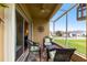 Screened lanai featuring a comfortable seating area and views of the neighborhood at 24321 Kintail Ct, Punta Gorda, FL 33980