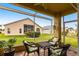 Enclosed patio with comfortable seating offers a relaxing outdoor living space with paver flooring and great back yard views at 24321 Kintail Ct, Punta Gorda, FL 33980
