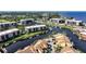 An aerial view showing a waterfront community with lush landscaping and serene canal views at 25188 Marion Ave # 1015, Punta Gorda, FL 33950