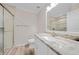 Modern bathroom featuring sleek vanity, granite countertop, and tiled glass shower enclosure at 25188 Marion Ave # 1015, Punta Gorda, FL 33950