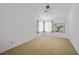 Bedroom with a ceiling fan, carpet, and a window at 25188 Marion Ave # 1015, Punta Gorda, FL 33950