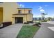 Inviting two-story condo featuring a screened garage, lush landscaping, and a paved driveway on a sunny day at 25188 Marion Ave # 1015, Punta Gorda, FL 33950