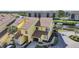 Inviting two-story yellow townhouse with a brick driveway, an attached garage, and waterway access with boats at 25188 Marion Ave # 1015, Punta Gorda, FL 33950