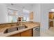 Functional kitchen area featuring granite countertops, stainless steel appliances, and a dual-basin sink at 25188 Marion Ave # 1015, Punta Gorda, FL 33950