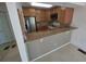 View of a kitchen with granite countertops and stainless steel appliances and wood cabinets at 25188 Marion Ave # 1015, Punta Gorda, FL 33950
