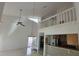 Living area with high ceilings, loft, stainless steel appliances in kitchen and natural light at 25188 Marion Ave # 1015, Punta Gorda, FL 33950