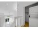 Loft area with laundry closet and view of the living room below at 25188 Marion Ave # 1015, Punta Gorda, FL 33950