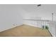 Loft area overlooking living space with a view of the outdoor greenery through the windows at 25188 Marion Ave # 1015, Punta Gorda, FL 33950