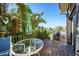 A well-appointed outdoor patio features a cozy table, chairs, and BBQ with lush greenery at 25188 Marion Ave # 1015, Punta Gorda, FL 33950