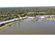 Aerial view of the home, situated by a lake with lush landscaping at 25225 Rampart Blvd # 604, Punta Gorda, FL 33983