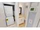 Convenient bathroom with stacked washer and dryer and granite countertop sink at 25225 Rampart Blvd # 604, Punta Gorda, FL 33983