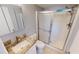 Cozy bathroom with walk in shower and granite countertop sink at 25225 Rampart Blvd # 604, Punta Gorda, FL 33983