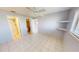 Comfortable bedroom with tile floors, ceiling fan, and view to bathroom at 25225 Rampart Blvd # 604, Punta Gorda, FL 33983