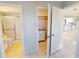 A glimpse into the closet and bathroom from the well-lit bedroom with tile floor at 25225 Rampart Blvd # 604, Punta Gorda, FL 33983