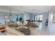 Bright living and dining area with blue walls, tile flooring, and a sliding glass door leading to a screened lanai at 25225 Rampart Blvd # 604, Punta Gorda, FL 33983