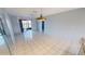 Bright living and dining area with blue walls, tile flooring, and a sliding glass door leading to a screened lanai at 25225 Rampart Blvd # 604, Punta Gorda, FL 33983
