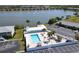 Beautiful community pool and lounging area overlooking a peaceful lake with fountain feature at 25225 Rampart Blvd # 604, Punta Gorda, FL 33983