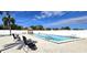 Inviting community pool with lounge chairs and a charming gazebo on a sunny day at 25225 Rampart Blvd # 604, Punta Gorda, FL 33983