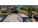 Aerial view of a home with a metal roof, screened in pool, and access to the lake at 26089 Templar Ln, Punta Gorda, FL 33983