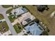 Aerial view of three houses with backyard pools and manicured lawns in a vibrant neighborhood at 26089 Templar Ln, Punta Gorda, FL 33983
